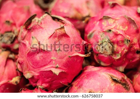 Exotic tropical fruit, dragon fruit or pitaya display for sell in market.selective focus shot. image may contain noise and grain due to available light shot