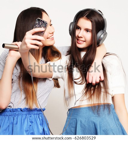 beauty hipster girls with a microphone singing and take picture 