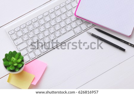 Top view image of open notebook with blank pages on wooden table