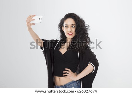 Beautiful girl taking self picture with smartphone