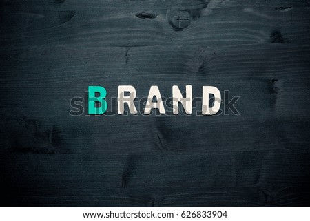 wooden word brand on background business concept