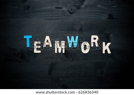 wooden word teamwork on background business concept