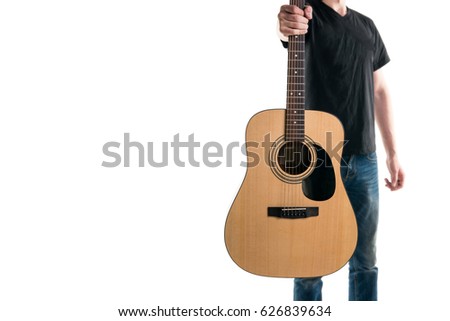 Guitarist in jeans and a black T-shirt, stretches an acoustic guitar, on the right side of the frame, on a white background. Play it!