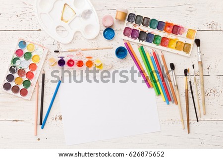 Top view on colorful paints and brushes. Creative ideas, creativity and early learning. Education concept.