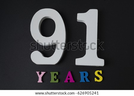 Letters and numbers ninety-one year on black isolated background.