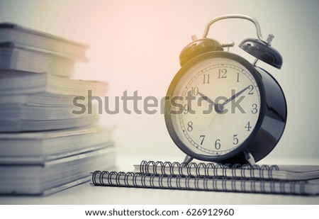 Vintage clock and stack of books