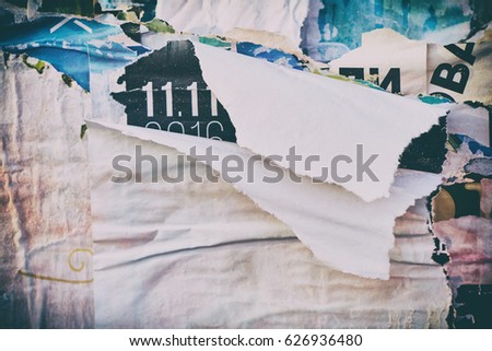 The texture of a wall with torn posters and ads. Bright abstract background ideal for any design                               