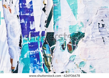 The texture of a wall with torn posters and ads. Bright abstract background ideal for any design                               