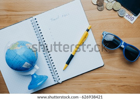 Flat lay travel concept with coins, cards, mobile phone, globe and coffee. Top view
