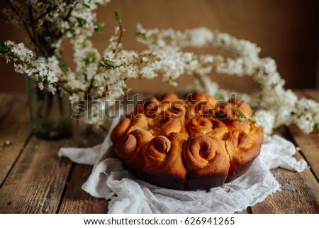 Beautiful cake and spring flowers on a wooden table

