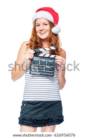 Vertical portrait of an actress with a rattle of a movie in a santa hat isolated