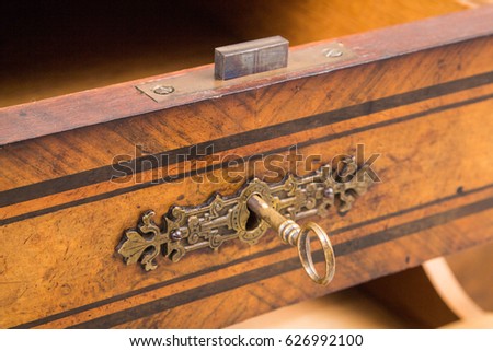 Antique desk lock and key Royalty-Free Stock Photo #626992100