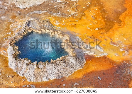 Close up picture of a small colorful hot water pool in Yellowstone National park, Wyoming, USA.