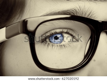 Portrait of a boy wearing eyeglasses blue eyes close, macro studio shot