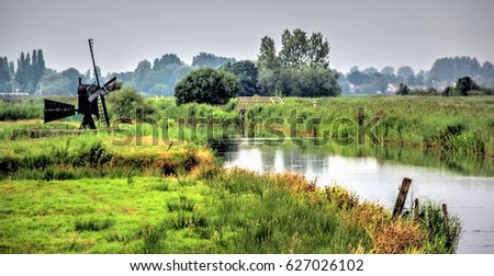 Authentic dutch landscape on a beautiful day Royalty-Free Stock Photo #627026102