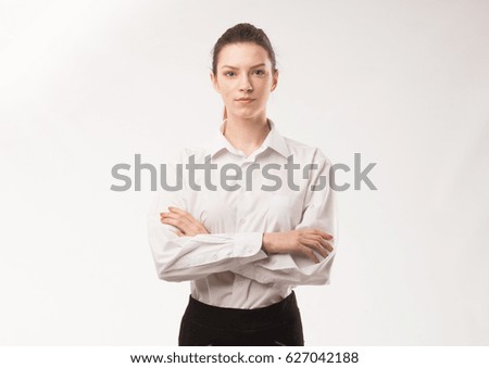 Young happy woman portrait of a confident businesswoman showing presentation, pointing paper placard gray background. Ideal for banners, registration forms, presentation, landings, presenting concept