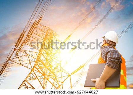 electric engineer check the high voltage pole Royalty-Free Stock Photo #627044027