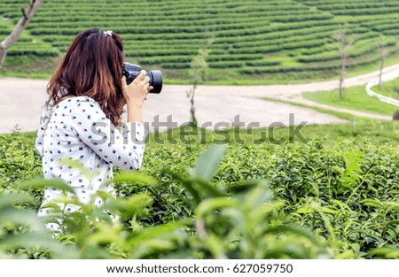 woman holding with photography vintage camera with soft-focus in the background. over light 