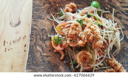 Thai famous traditional street food papaya salad with pork rind. Image for background, wallpaper, copy space