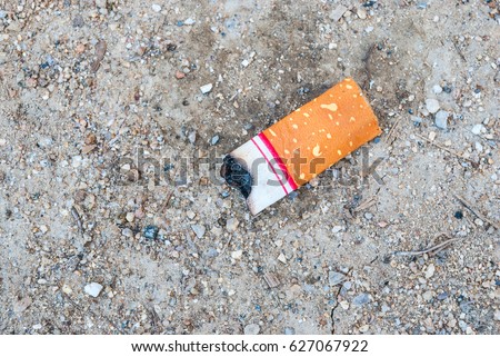 Closeup to Short Cigarette Stub on Ground