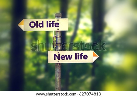 Signpost in a park with arrows old and new life pointing in two opposite directions Royalty-Free Stock Photo #627074813