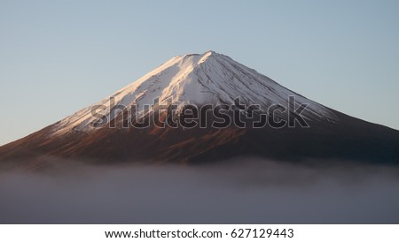 Fujiyama mountain painted by sunrise light with foggy mood Royalty-Free Stock Photo #627129443