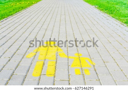 Pedestrian lanes sign on walkway and green grass field background.