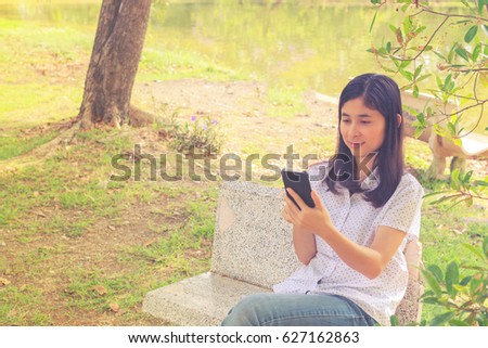 Hipster beautiful girl relaxing in the park while read book