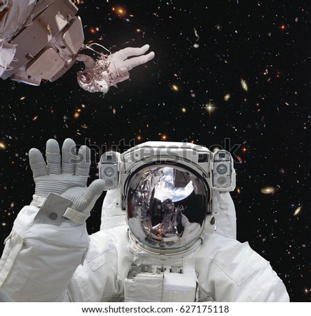 Astronaut spaceman in outer space. Other astronaut on backdrop. "The elements of this image furnished by NASA"
