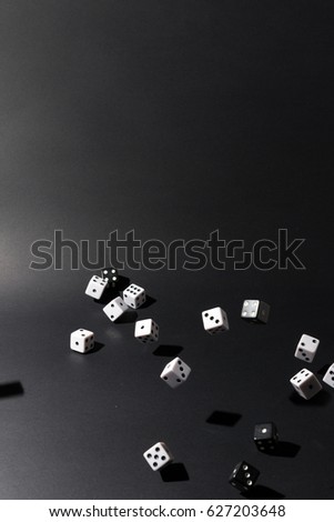 Dice fall over black background.