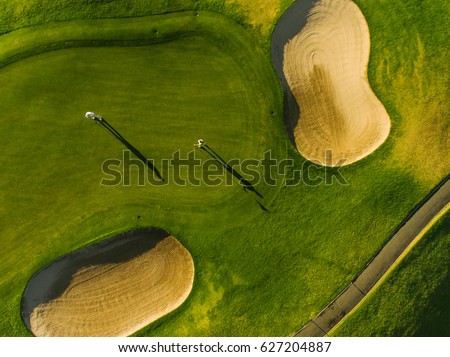 Golf course top view with players. Aerial view of golfers on putting green.