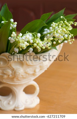 Beautiful bouquet of lily of valleys in an elegant vase