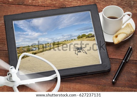 aerial photography concept with a digital tablet, drone propeller and coffee,  screen picture copyright by the photographer