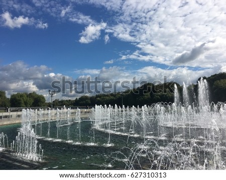 Water fountain and blue cloudy sky