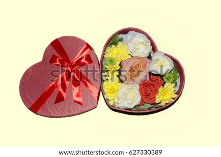 Gift box in the form of a heart with roses, chrysanthemums and tulips on a gentle background,to the day of Saint Valentine