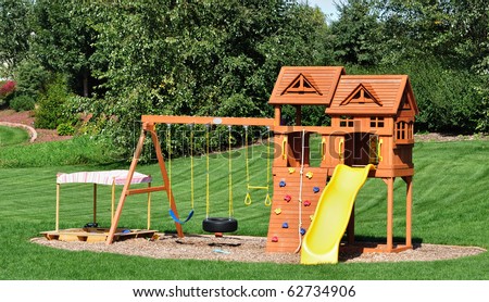 Back Yard Wooden Swing Set on Green Lawn Royalty-Free Stock Photo #62734906
