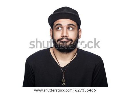 Portrait of young thoughtful confused man with black t-shirt and cap thinking. studio shot, isolated on white background.