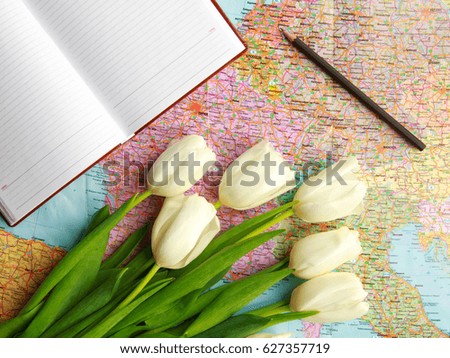 Flowers tulips on the tourist map of the world concept of leisure and travel