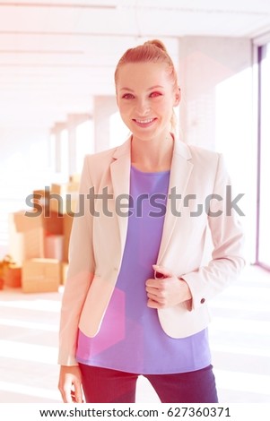 Portrait of beautiful young businesswoman smiling in new office