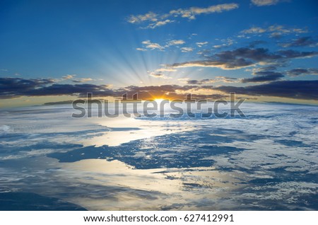 Rays of the Rising Sun over the Planet Earth.  Elements of this image furnished by NASA (http://www.nasa.gov/) Royalty-Free Stock Photo #627412991