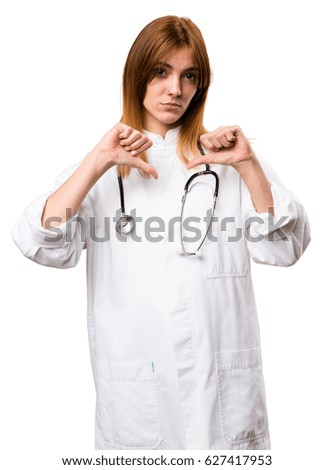 Young doctor woman making bad signal