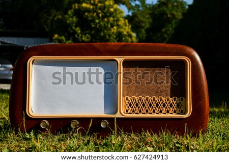Photo Picture of an Old wooden radio on a grass background