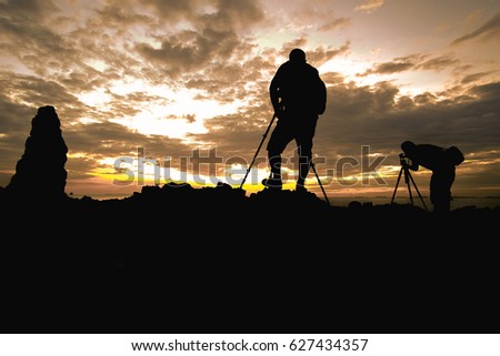 Silhouette photographer In the sunset background