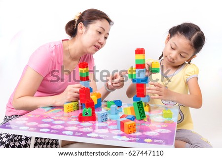 Mother and child daughter playing together