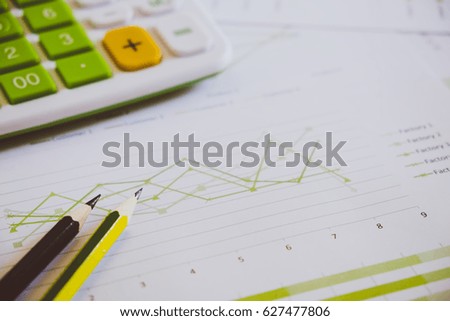 Many charts and graphs with pencil, calculator, clock. Reflection light and flare. Concept image of data gathering and statistical working.
