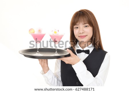 Young waitress serving cocktails