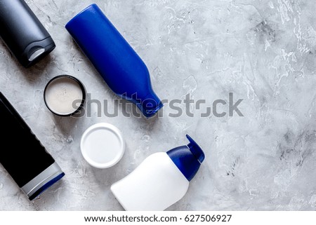 cosmetic for men in bottle on gray background top view