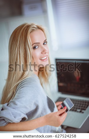 Young beautiful woman using a laptop computer at home