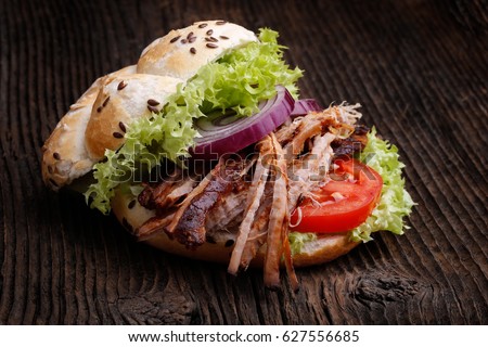 Pulled pork burger with coleslaw tomato, onion and fresh bread. Meat burger.