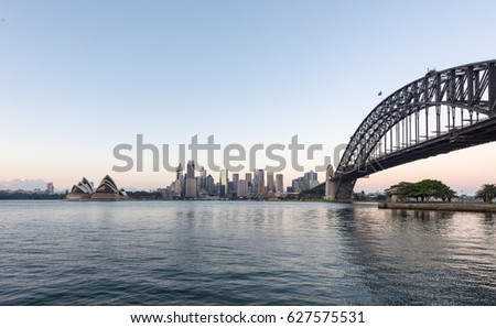 Beautiful sunrise over Opera House and Sydney Harbour Bridge viewed from Kirribilli in North Sydney.